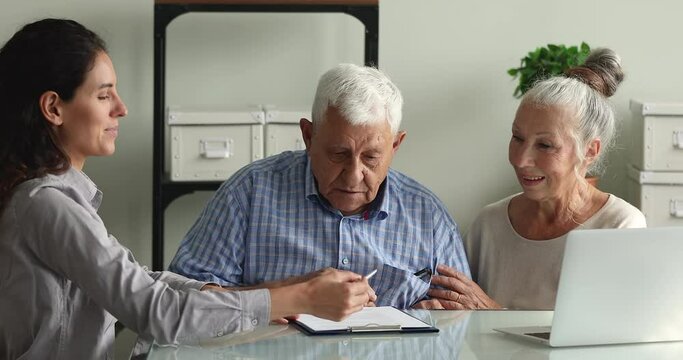 Happy aged couple clients shake hands with advisor agent lawyer after sign a contract make deal, express gratitude for qualified consultation received. Insurer sell medical insurance services concept