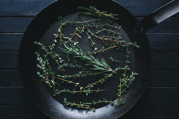 Fresh Mediterranean herbs thyme and rosemary in a frying pan Healthy food