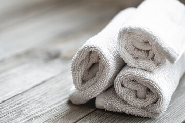 Fototapeta na wymiar Close up of rolled bath towels on blurred background.