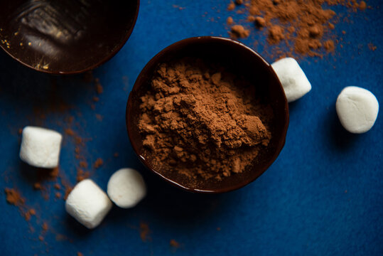Partially filled chocolate shells for hot chocolate bombs.