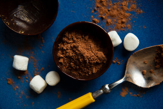 Partially filled chocolate shells for hot chocolate bombs.