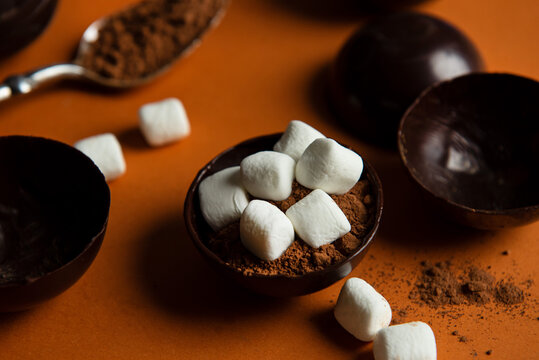 Partially filled chocolate shells for hot chocolate bombs.