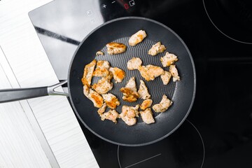 Preparing low fat fried chicken for dinner on induction plates