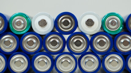 Lots of AA and AAA alkaline batteries on a white background. Ecological recycling concept. The...