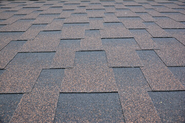 Copper brown roofing asphalt shingles texture background. A close-up of an asphalt laminated,...