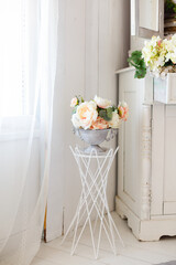 Beautiful tender bouquet on elegant white stand