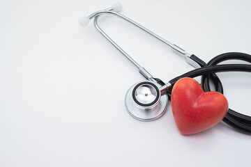 stethoscope and red artificial heart on a white background