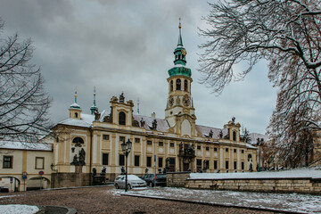 Fototapeta na wymiar View of Loreto Sanctuary in winter,Prague,Czech republic.Marian pilgrimage site with the Baroque Church surrounded by cloisters and chapels.In the tower there is bell carillon that plays a song