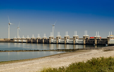 Netherlands, August 2019. In Zeeland, wind farms are the setting for the immense dam that governs...