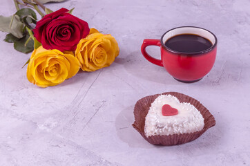 a bouquet of roses, a cup of coffee and a heart-shaped cake. Romantic breakfast