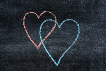 Obraz premium Red and blue heart on a chalk board. Valentines day concept