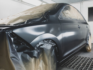Car at the stage of painting in the workshop