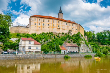 Fototapeta na wymiar Panoramic view of castle above river in Ledec nad Sazavou. Sazava river is famous target for kayaking. Summer weather with dramatic clouds. Czech Republic.