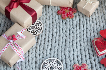 Gift boxes with ribbons on a handmade knitted cozy background. Christmas and New year concept. Valentine's Day presents. Happy Birthday. 