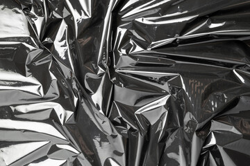 Plastic texture. Wrap transparent dark cellophane background. Black shiny film bag pattern. Real...