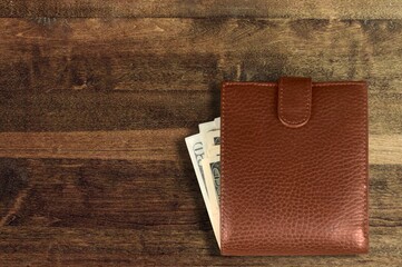 Leather man purse or wallet on wooden desk