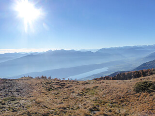 A distant view on the Millstaetter lake in Austrian Alps. Sunny and bright autumn day. The lake is...