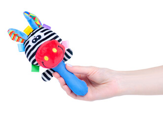 Toy soft rattle in hand on white background isolation