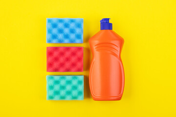 cleaning products display nolling on a yellow background, top view