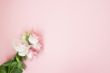 Fototapeta na wymiar Flowers composition. Pink rose flowers on pastel pink background. Flat lay, top view, copy space