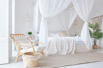Cozy interior of a bright Balinese-style apartment with white walls, bamboo furniture. bed room...