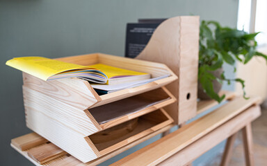Paper and document wooden tray holders and organisers on desk, natural decor concept.