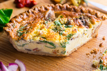 Quiche. Farm fresh eggs mixed with spinach, bacon, ham, sausage, cheese, vegetables poured in a pie crust and baked. Classic American restaurant or French Bistro breakfast or brunch favorite.