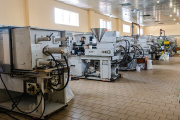 Production of plastic containers. Industrial factory interior with equipment and steel tools.