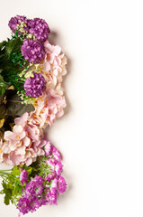 bouquet of pink flowers on the left side on a yellow background and a pink leaf