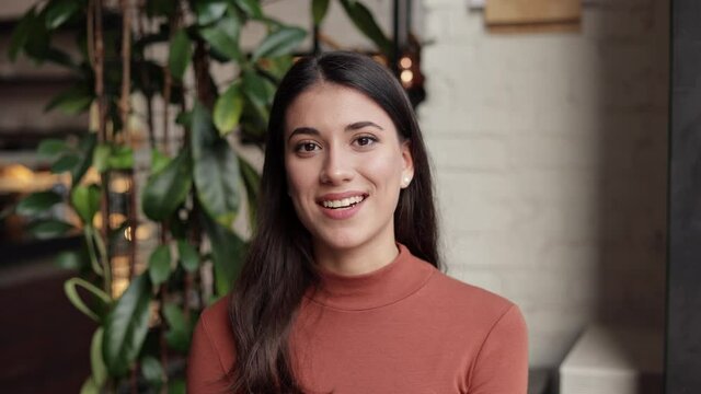 Smiling young female tutor talking to web camera. Recording vlog, online video conference, video call, online education, lessons, lecture. Job interview, online training. Webcam view