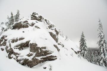 VELEBIT MOUNTAIN, ZAVIZAN - 2.1.2021. Northern Velebit National park covered with snow. Cloudy cold day in the mountains. Rock covered with snow.