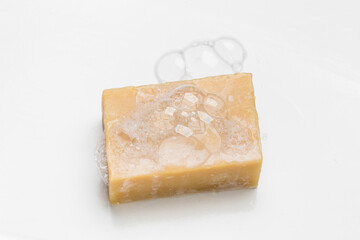 Soap bar and foam on white background, top view. Mockup for design