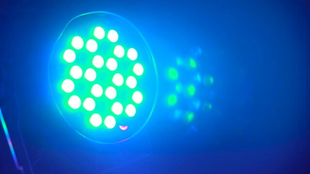 Closeup shot of static multicolor projector spot lights on stage. Footage. Shot of searchlight shim with different colors. Party or disco equipment. Entertainment industry concept.