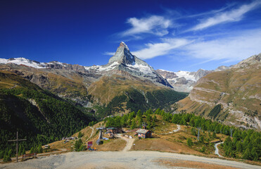 Matterhorn view with shining sun on a good summer day and clouds