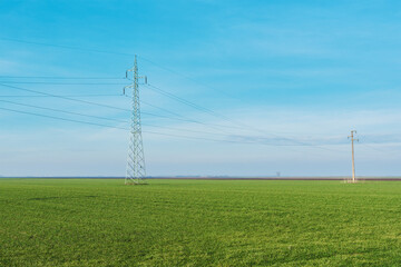 Electric power transmission, electricity power line pylons in countryside fields