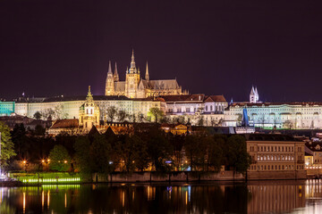 Charles Bridge in Prague in the evening with colorful lights from lanterns