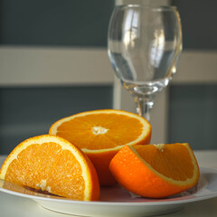 Fototapeta na wymiar Slices of oranges lying next to a bottle of fresh orange juice