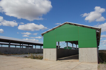 Hangar warehouse. Construction of hangars from a metal frame and modern wall material from sandwich panels. Prefabricated buildings from frame and panels