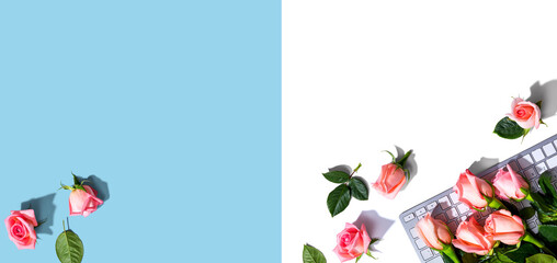 Computer keyboard with pink roses - flat lay