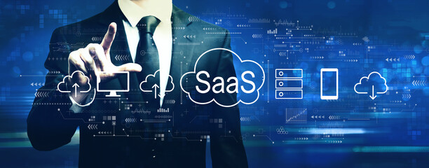 Fototapeta na wymiar SaaS - software as a service concept with businessman on a dark blue background
