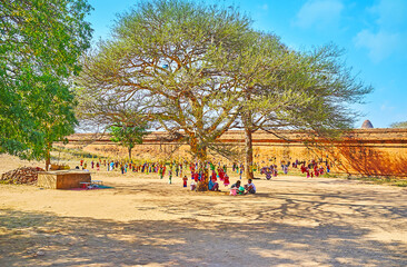 The string puppets stall under the tree, Dhammayangyi Temple market, Bagan, Myanmar