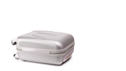 Suitcase white background. Silver plastic luggage or vacation baggage bag isolated. Copy space of summer vacation and business travel concept.
