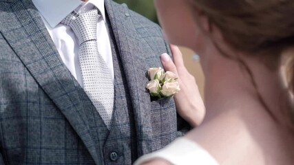 the bride strokes the groom's hand on the shoulder
