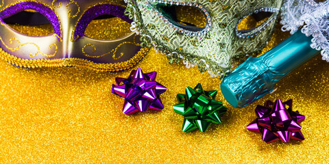 Carnival mardi gras party masks on golden background with decor. Gold, purple, green colors © tenkende