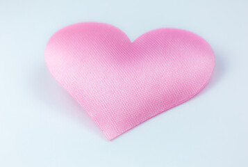 Pink heart on white background. Saint Valentine's day concept. Love and romantic photo. Postcard for holiday. Beautiful warm wallpaper with love. Soft focus. Copy space.