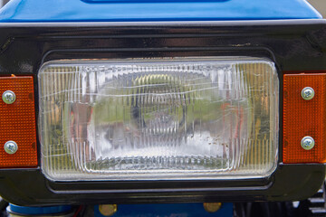 tractor headlight,close up of a square headlight of a two-wheeled motor tractor