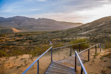 A staircase leading to the top of the Sarykum dune overlooking the Narat-Tyube ridge. The Republic of Dagestan. Russia