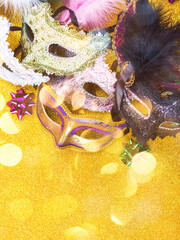 Carnival mardi gras party masks on golden background with decor. Gold, purple, green colors