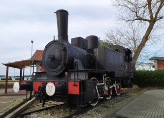 Fototapeta na wymiar Black locomotive on the Railway station Pula in region Istria in Croatia in Europe. It's located near the shipyard Uljanik