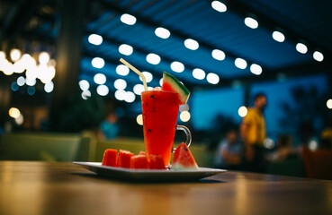 watermelon juice on the table. bokeh background in cafe. wood table 